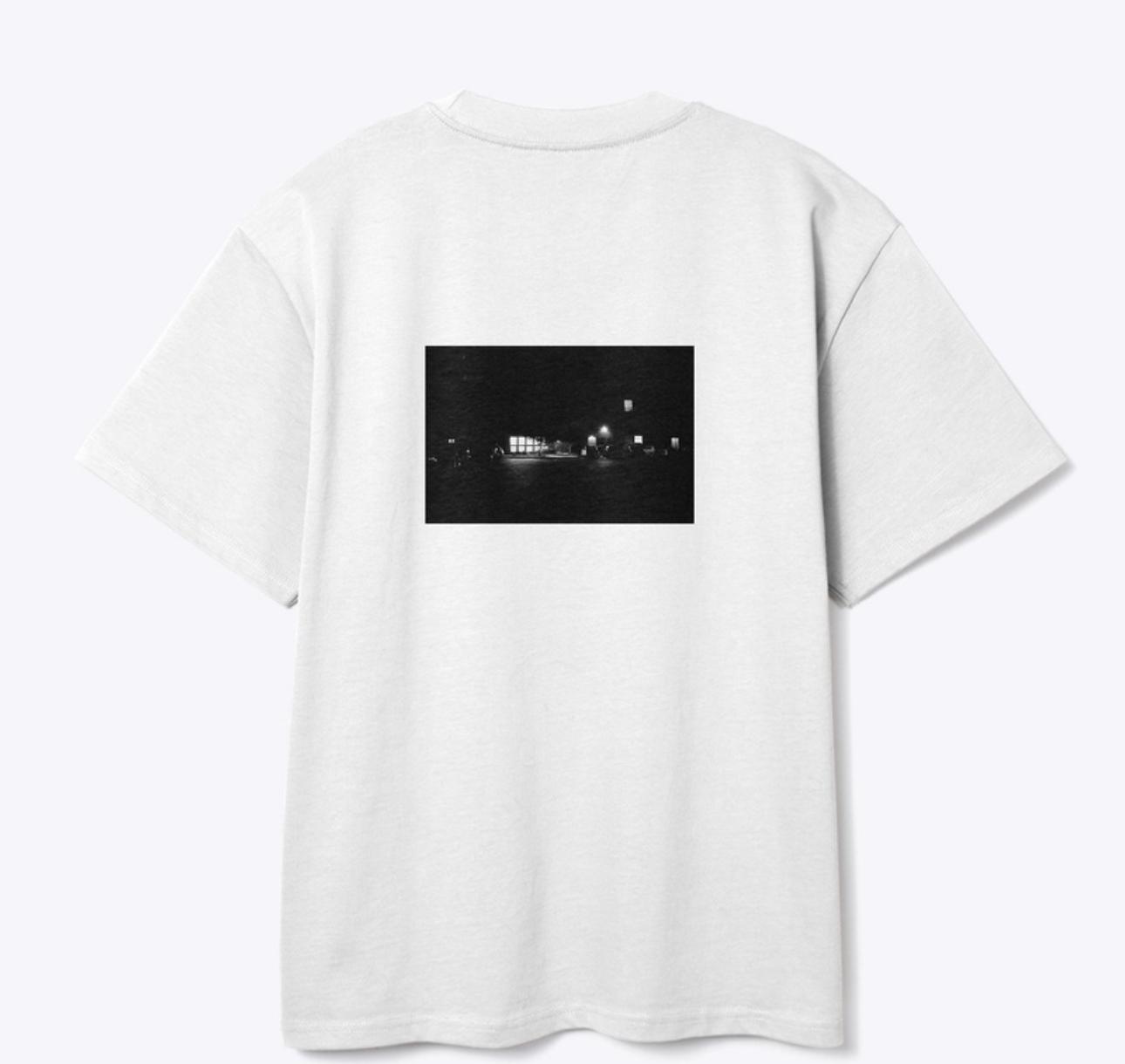 Back of a white WATY T-shirt with a black-and-white night scene